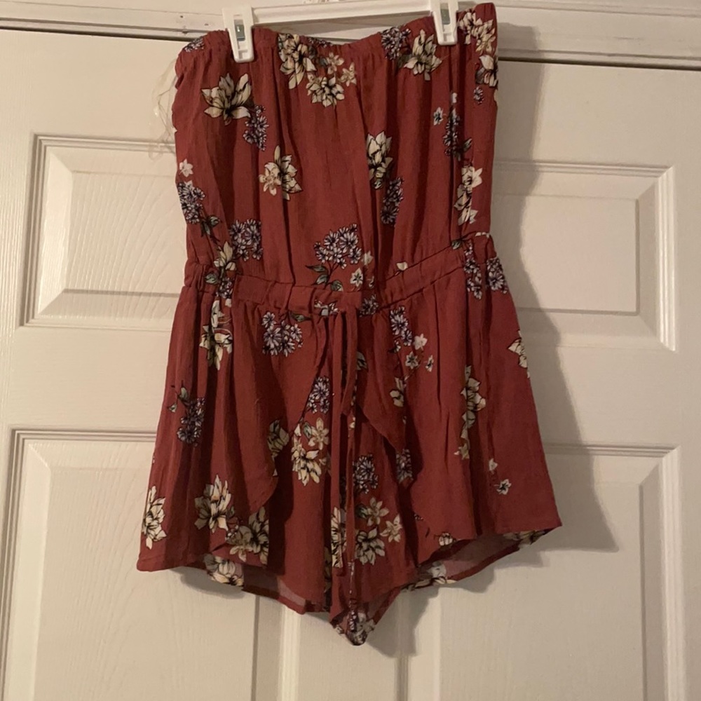 Rose colored romper with flower design.